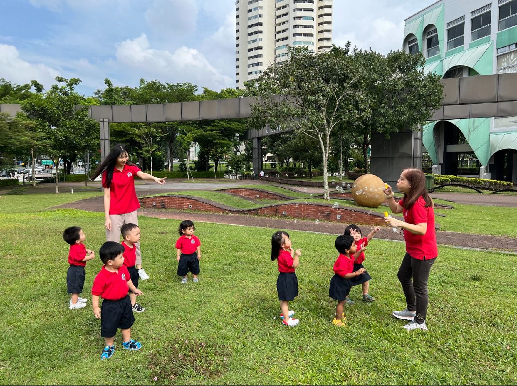Children and teachers at MapleBear Jurong Gateway playing outdoors